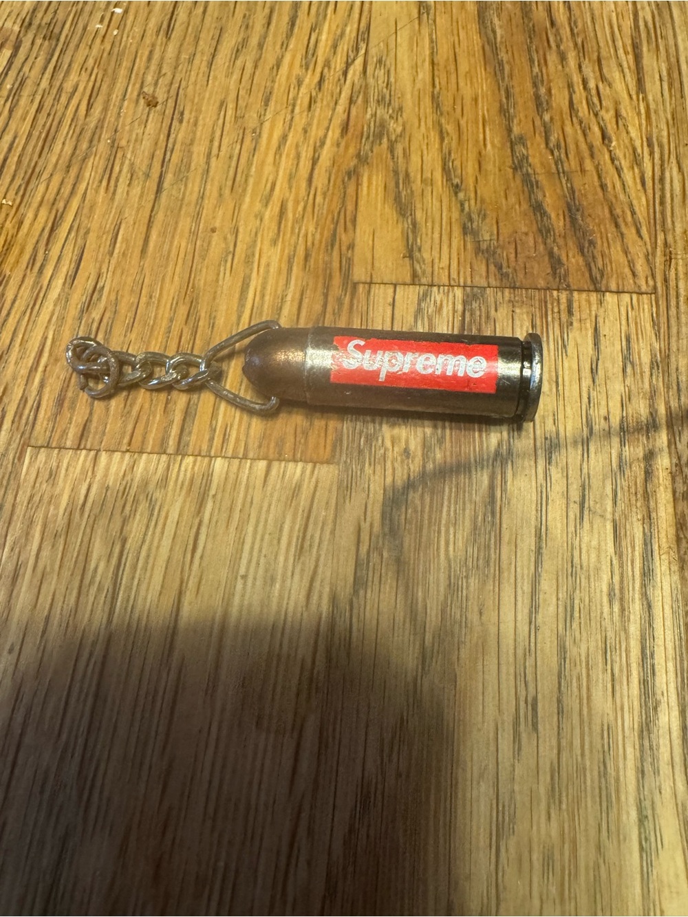 Supreme Bullet Keychain with Red Logo on Brass Shell